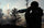 Darkened silhouette of a moose guide using a brich bark tube to call for bull moose