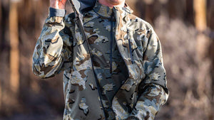 A man wearing a valo camouflage baselyer and a valo camouflage outer layer