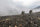 Side of Hunters Walking Exposed, Rocky Ridge Wearing Vias Camouflage with Fog in Background