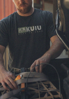 Man wearing KUIU Here to Hunt Logo T-Shirt in Charcoal Grey
