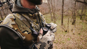 Close-up of a deer hunter in a tree stand wearing KUIU's Proximity vest.