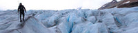 Hunter walks on a icy mountain top, surrounded by icy crevices