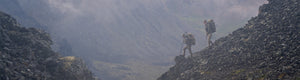 Back of Hunter in Verde Camouflage Overlooking Foggy Valley