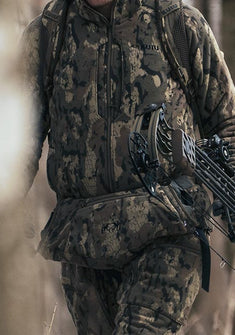 Close-up of hunter wearing KUIU Proximity Hooded Insulated Jacket and hand muff in Veros Camouflage.