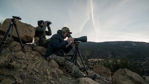 Two hunters seated on the side of a mountain glassing in head-to-toe KUIU.
