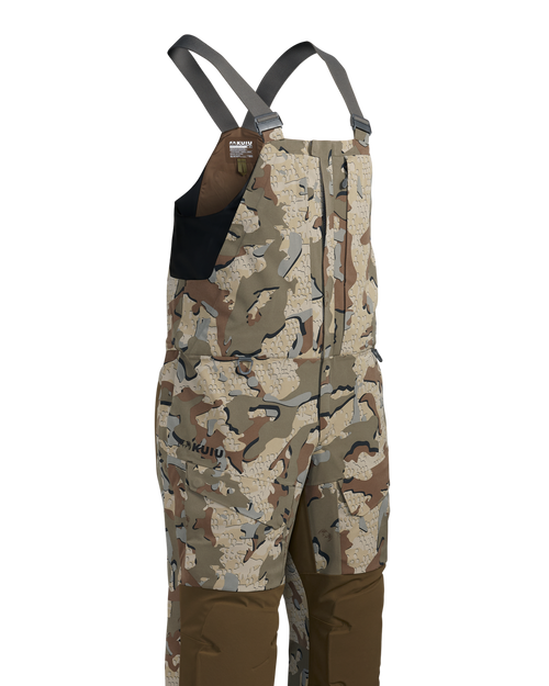 Front of KUIU's Paragon Storm Shell Bib in Valo camouflage.