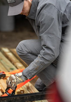 Hunter strapping lumber together, wearing Brawley Canvas Jacket and Pant in Gunmetal Grey
