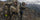 Two men standing on a mountain top and glassing.