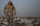 Waterfowl Hunter walking through a field of snow goose decoys with Paragon Storm Shell Jacket, Pant, and Hand Muff in Valo Camouflage.