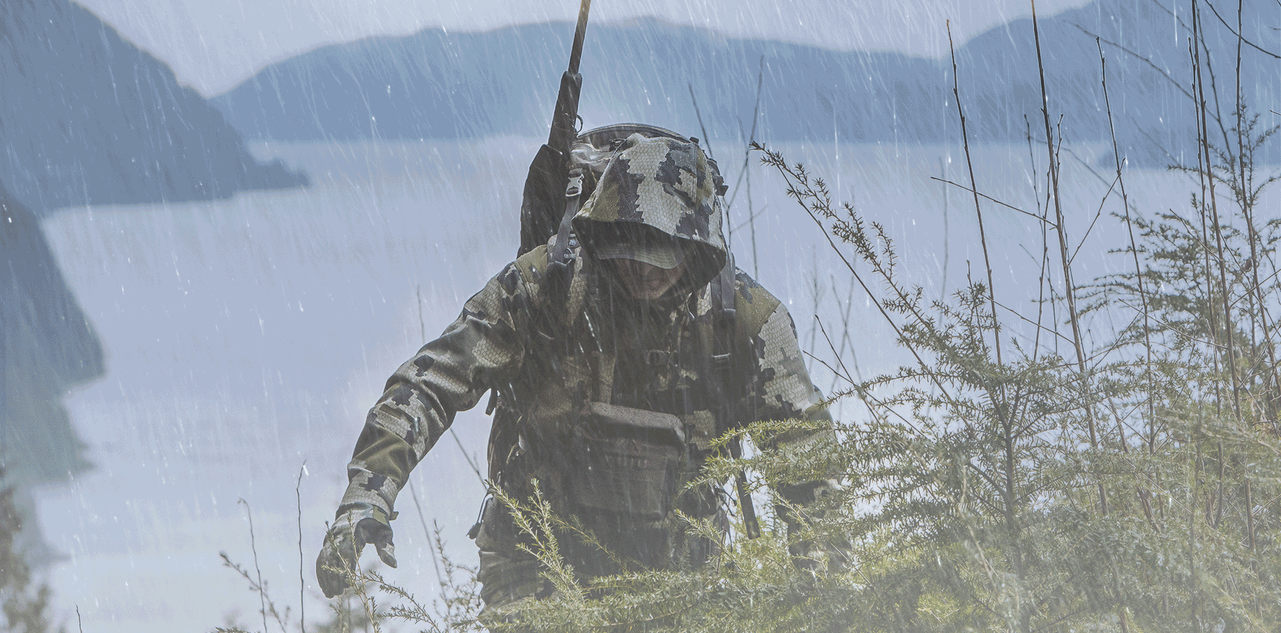 Front of Hunter Hiking in Rain Storm Wearing Verde Camouflage