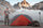 Greg McHale standing next to his Mountain Star 2 Person Tent in Gunmetal Orange with a glacier in the background