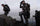 Two adult and one youth hunter all wearing Vias camouflage as they use binoculars to glass for animals