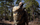 Back of Hunter Wearing Venture Divide 3000 Day Pack in Valo Camouflage Highlighting Spotting Scope/Tripod Storage in Divide Pass Through Pocket