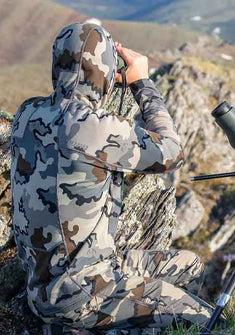 Rear Angled View of Hunter Glassing Game from Ridge Top Wearing Vias Camoufalge
