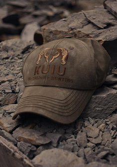 Close-up of KUIU Icon Cap in Ash Brown on a pile of rocks 
